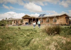 a cute photo of two girls running towards the Eco Lodge a gorgeous spot and a one of the best Hawkes Bay activities 